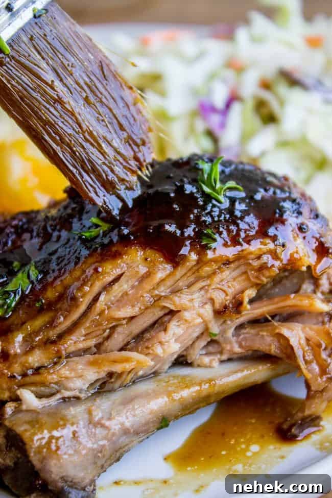 slow cooker pork ribs being brushed with honey balsamic glaze
