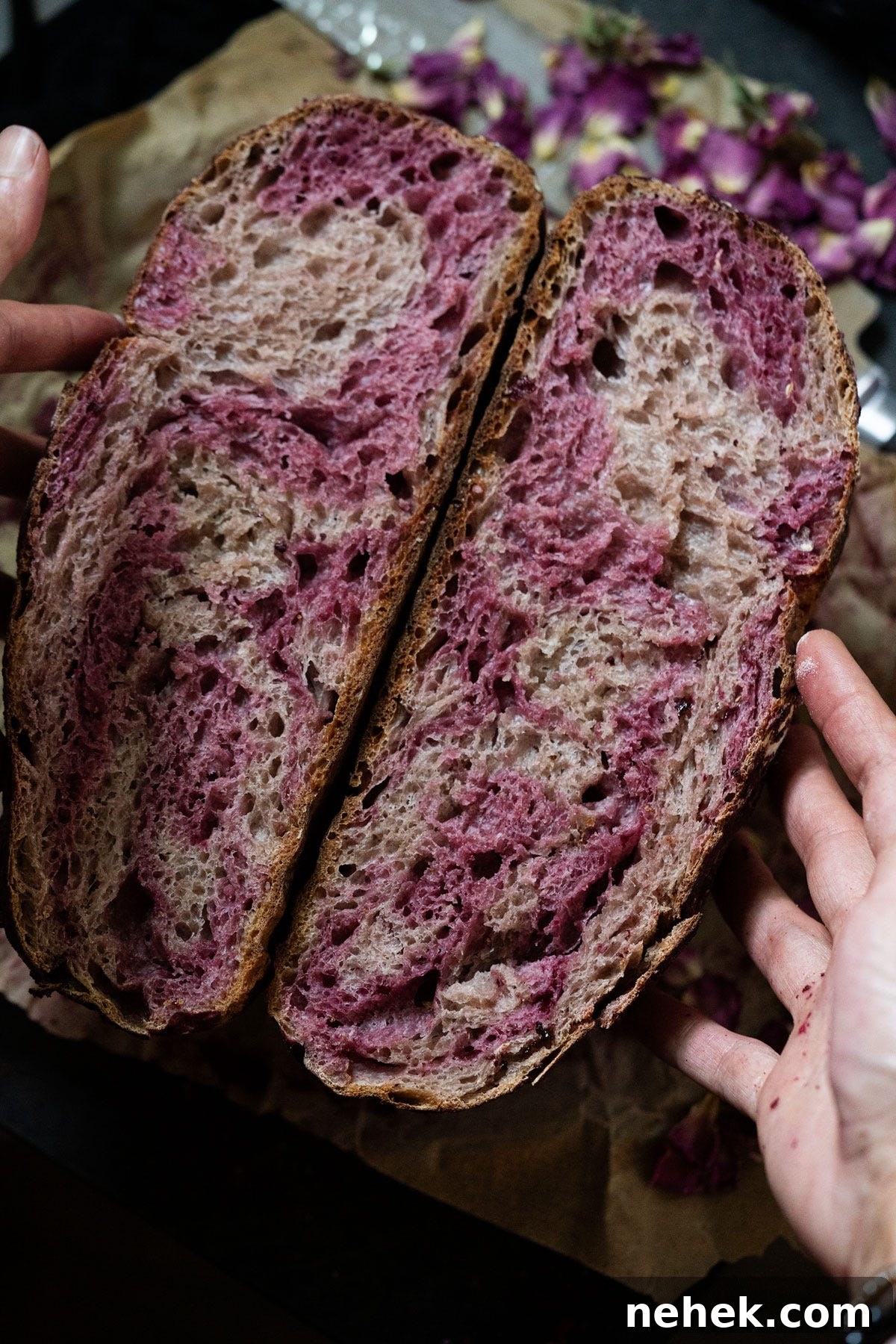 Create and Maintain a Sourdough Starter: Step-by-Step Guide 4 A rose sugar strawberry sourdough halved showing a marbled pink crumb