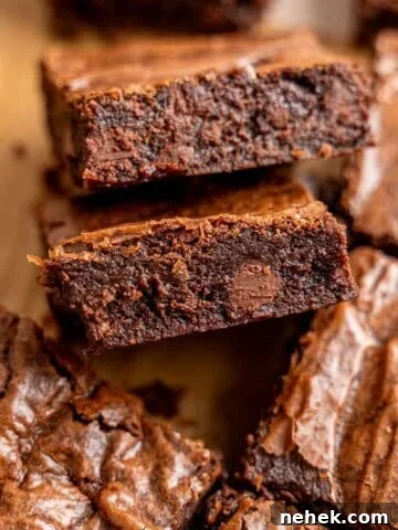 Slices of fudgy small batch brownies with chocolate chips and crinkly tops.