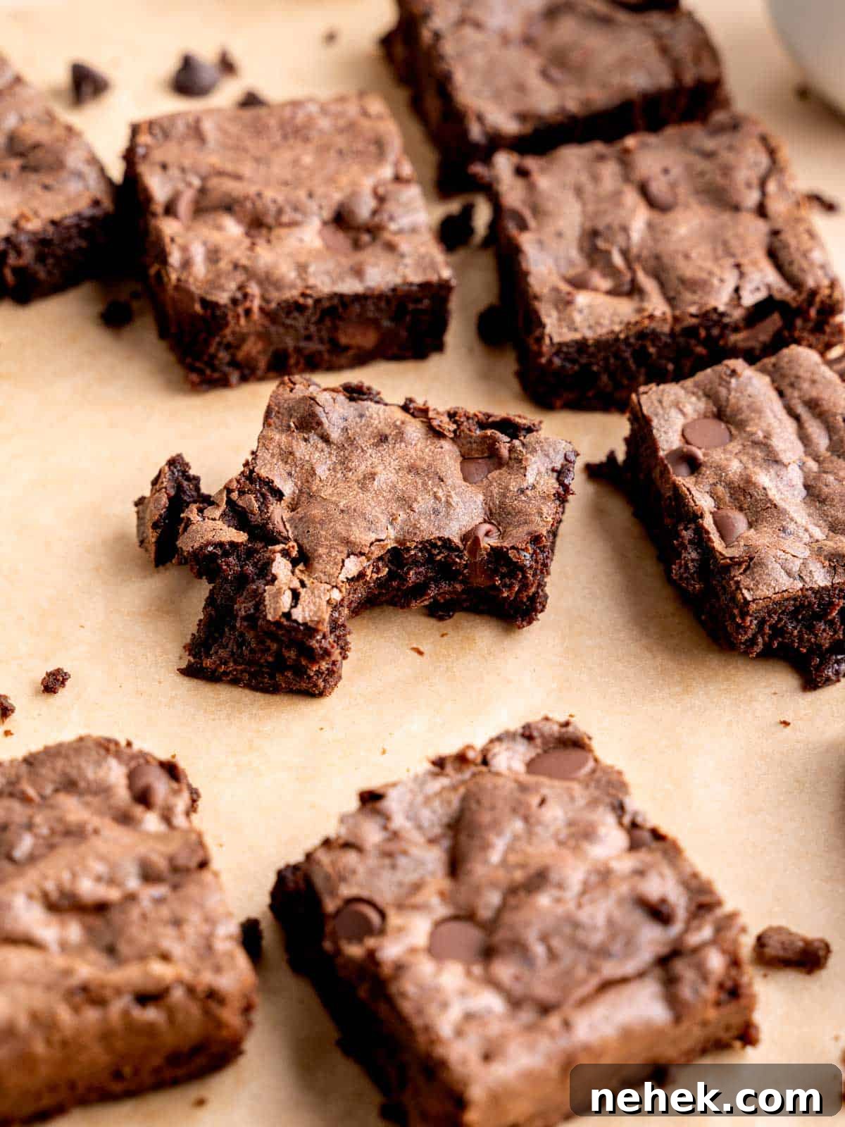 Fudgy Sourdough Discard Brownies You’ll Crave 10 Sourdough brownies cut into squares with a bite taken out of one.
