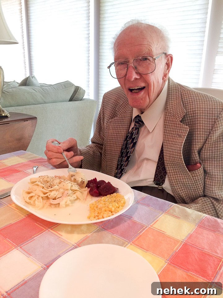 Creamy Chicken and Noodles Served Over Garlic Mashed Potatoes 11 A grandfather eating homemade chicken and noodles over mashed potatoes.