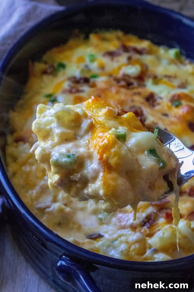 Loaded Cauliflower Casserole Recipe: Cheesy Bacon & Veggie Bake 7 Loaded Cauliflower Casserole on a serving spoon