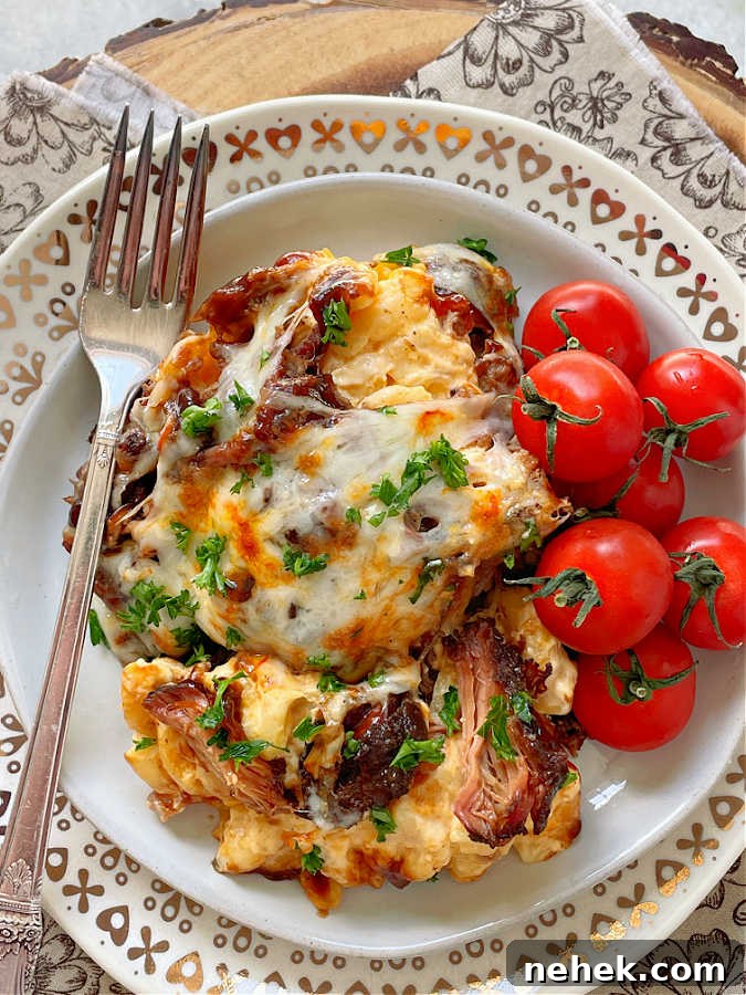 Smoky BBQ Mac and Cheese Recipe for Crowd-Pleasing Comfort 2 bbq mac and cheese on a plate with cherry tomatoes on the side