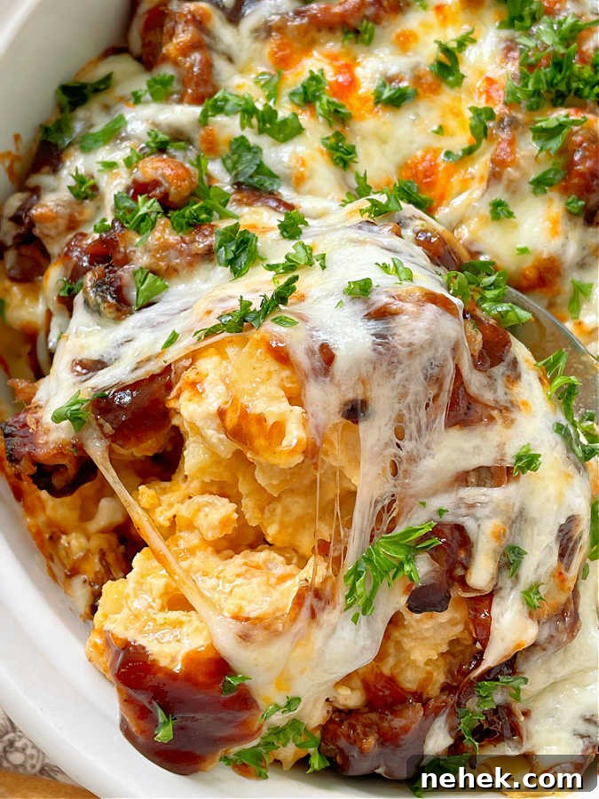 Smoky BBQ Mac and Cheese Recipe for Crowd-Pleasing Comfort 6 taking a spoonful of the bbq mac and cheese