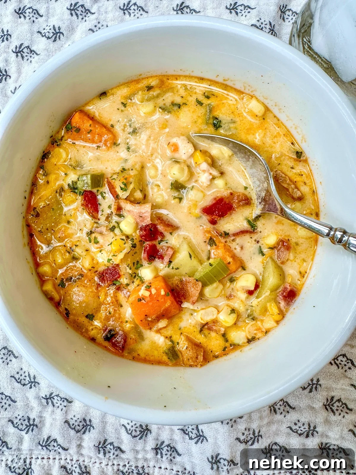 Creamy Corn and Potato Soup Recipe — Comforting Weeknight Soup 12 Corn and potato soup with bacon and chicken in a serving bowl.