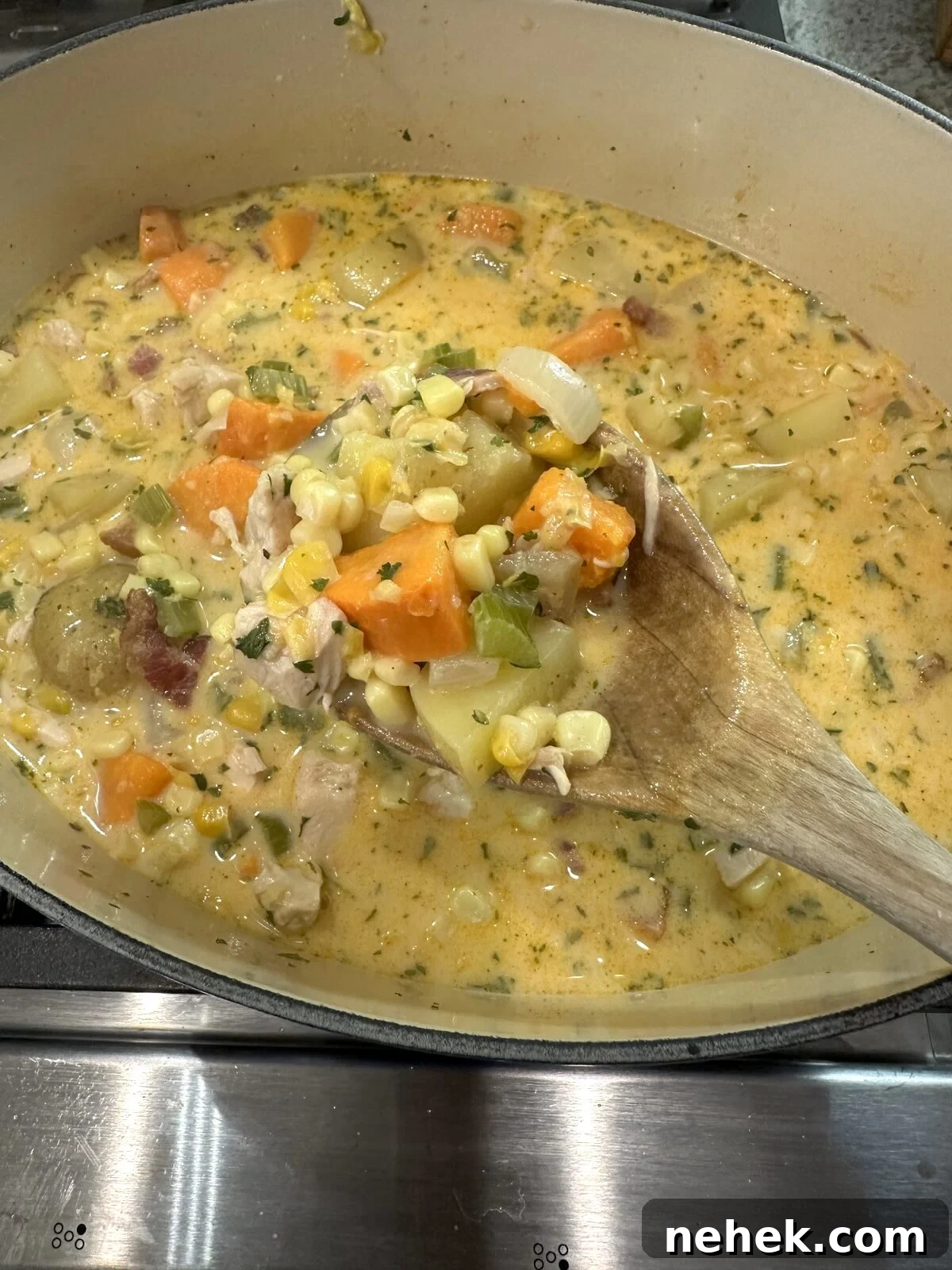 Creamy Corn and Potato Soup Recipe — Comforting Weeknight Soup 10 Corn and potato soup in a pan.