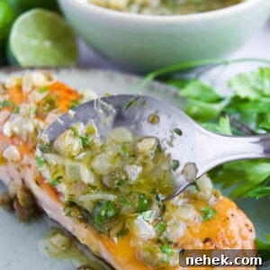 caper sauce is spooned onto a filet of salmon