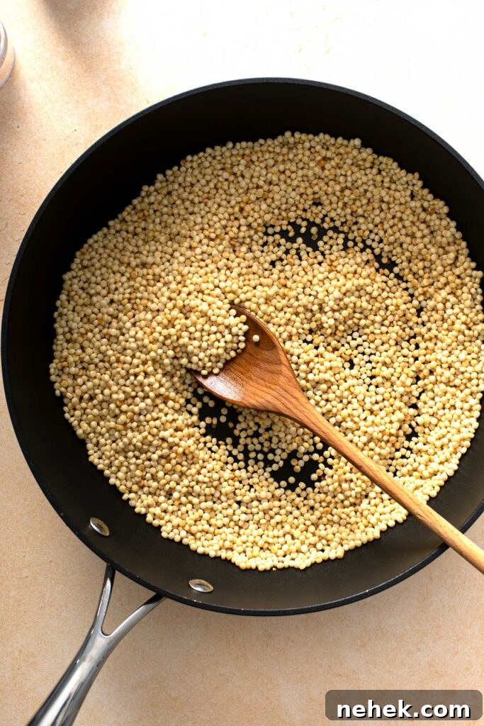 Toasting pearled couscous in a skillet