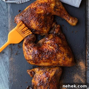 How to Smoke Chicken Leg Quarters for Juicy, Flavorful Results 17 Smoked chicken quarters on a slate plate topped with BBQ sauce.