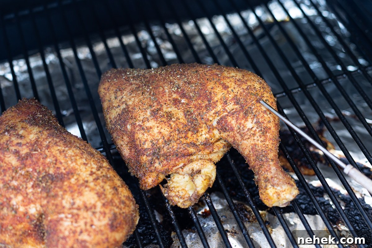 How to Smoke Chicken Leg Quarters for Juicy, Flavorful Results 8 Chicken quarter on smoker racks with internal meat thermometer in the leg.