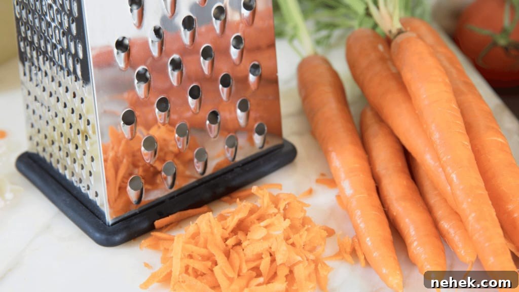 Shred carrots using a box grater