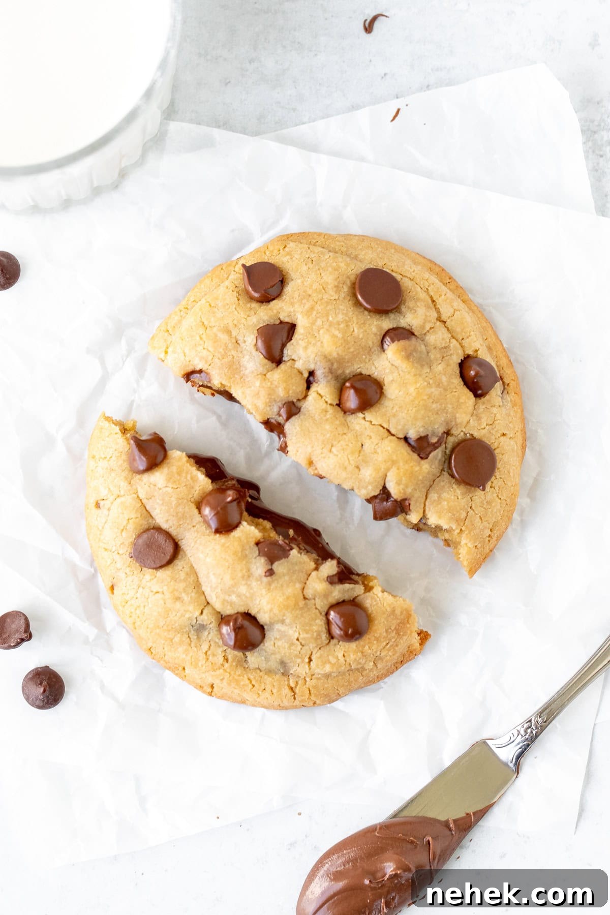Single serving chocolate chip cookie stuffed with Nutella , broken in half