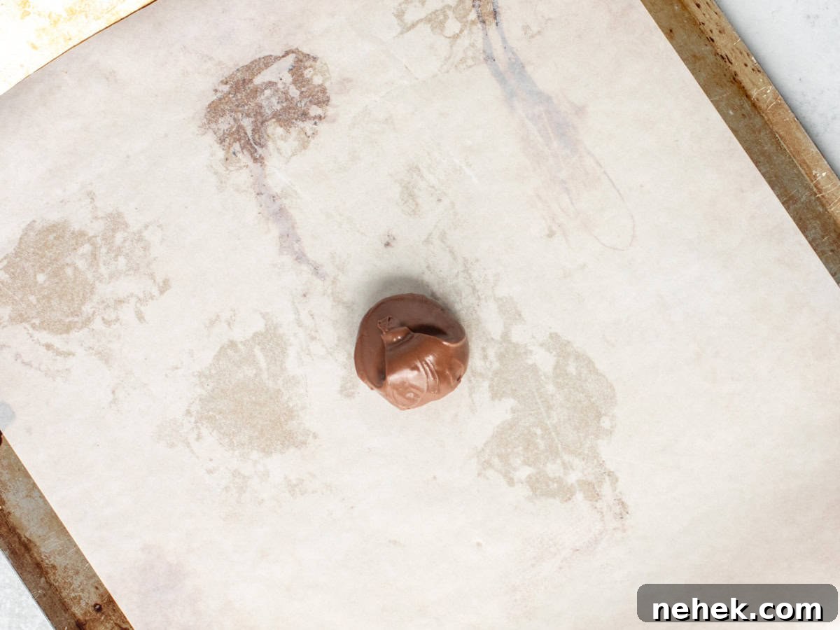 Dollop of Nutella on a lined cookie sheet
