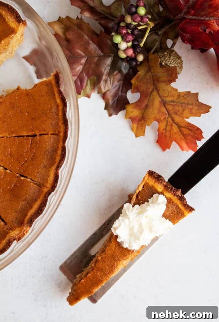 thin slice of keto pumpkin pie next to fall foliage