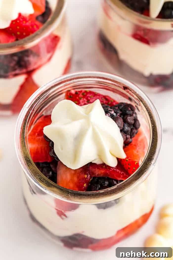 overhead zoomed in view of keto mousse in a small glass jar with berries