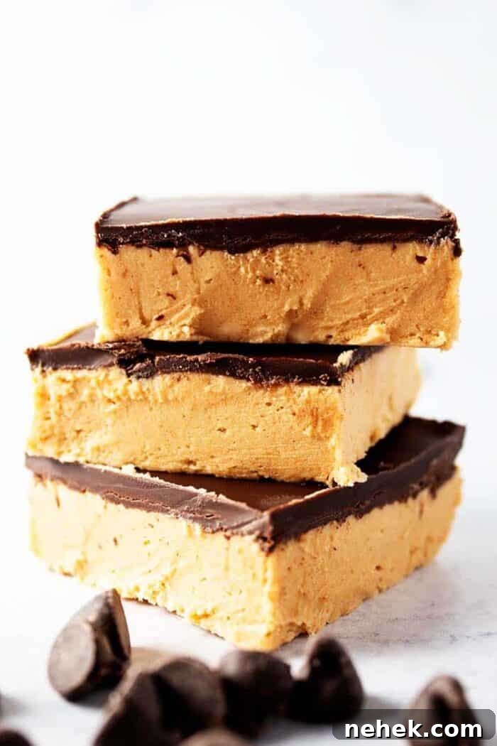 side view of three pieces of keto no bake peanut butter bars with chocolate chips scattered in front