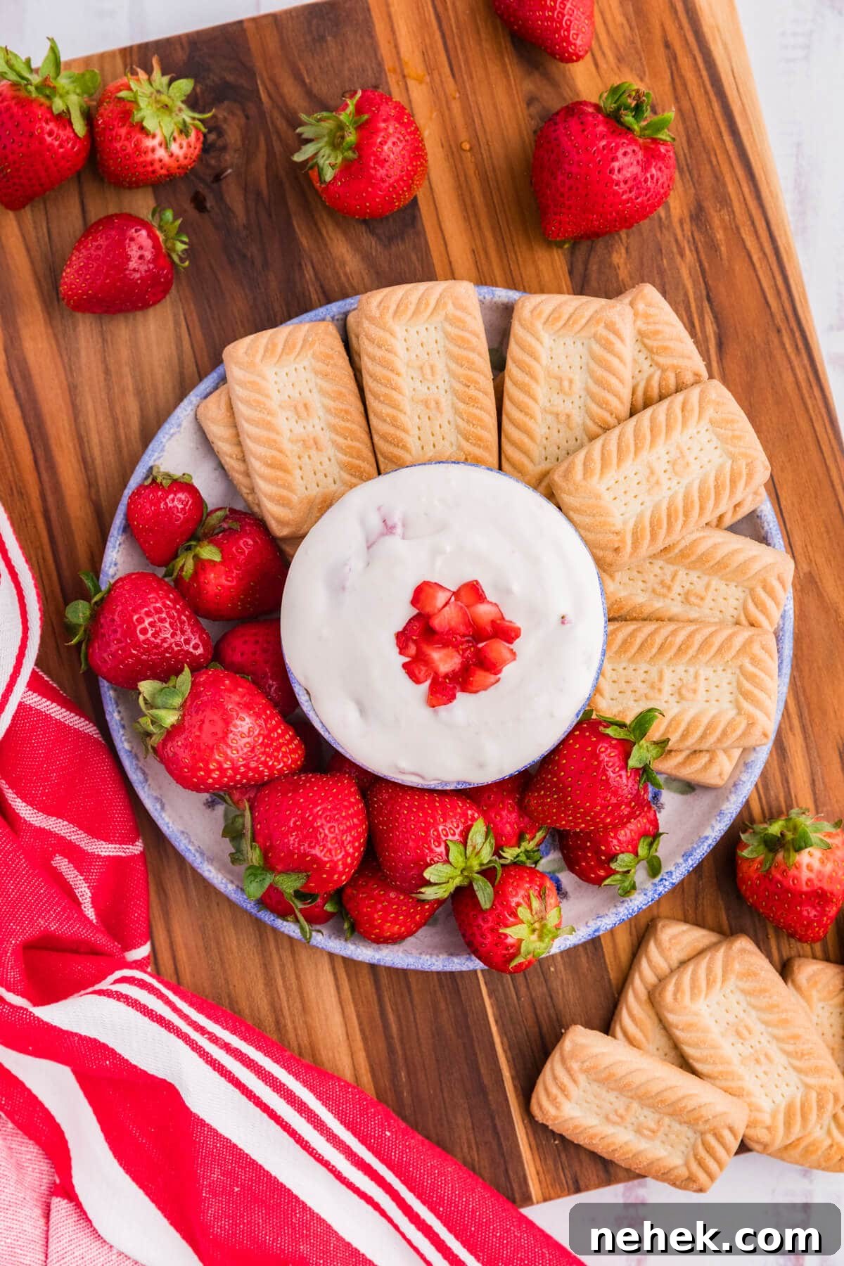Creamy Strawberry Cheesecake Dip Recipe for Parties 5 The dip on a platter with cookies and strawberries.