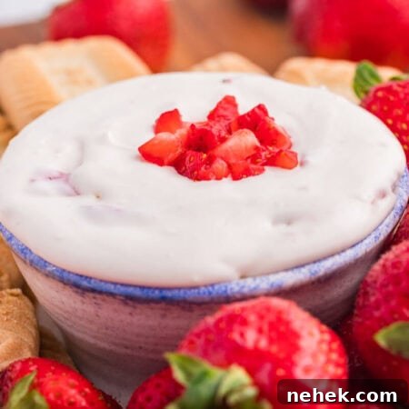 Creamy Strawberry Cheesecake Dip Recipe for Parties 8 The dip on a platter with cookies and strawberries.