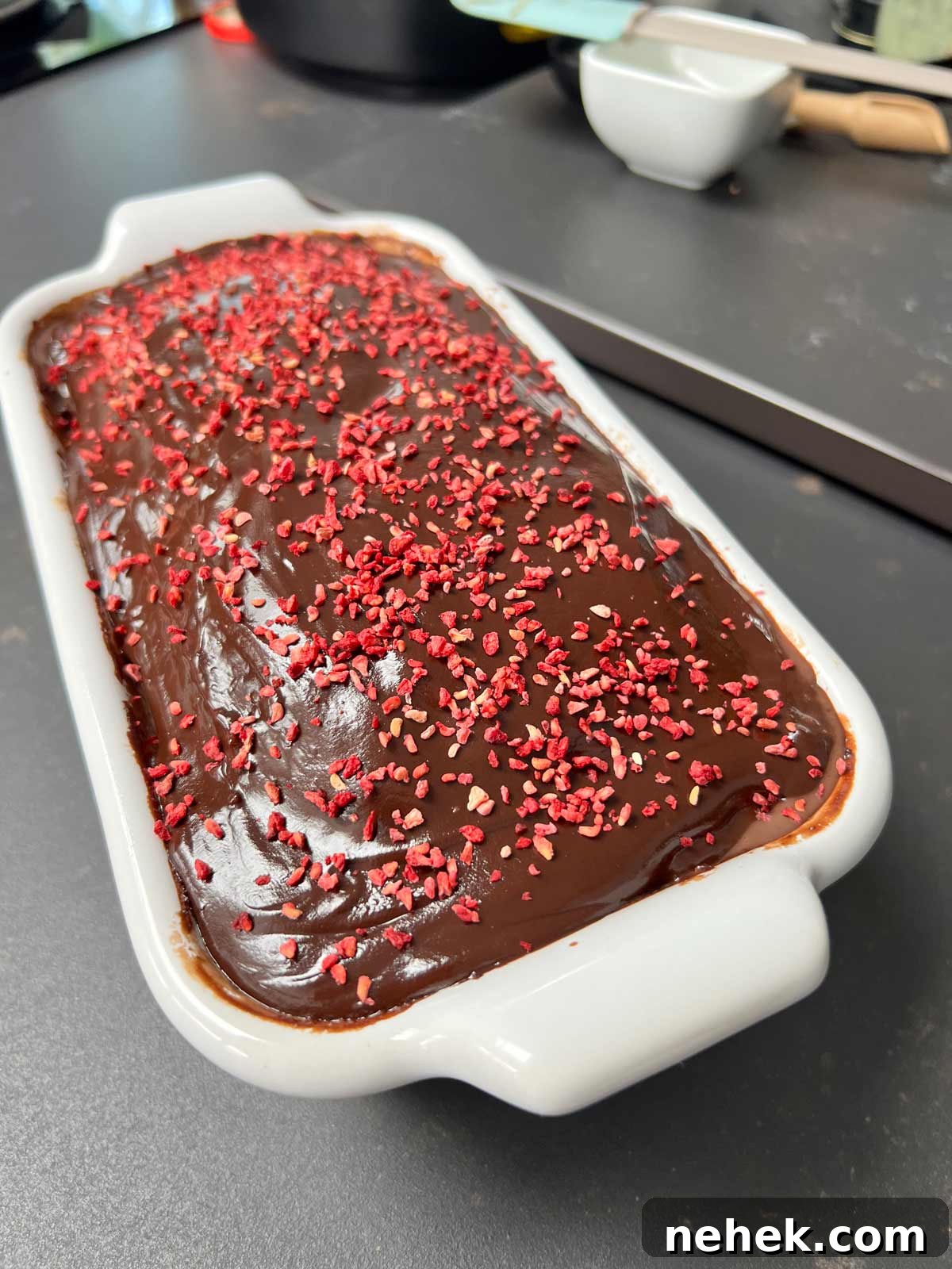 Ultimate Moist Chocolate Cake Recipe for Rich, Decadent Results 2 Chocolate cake toppped with ganache and sprinkled with dry raspberries.