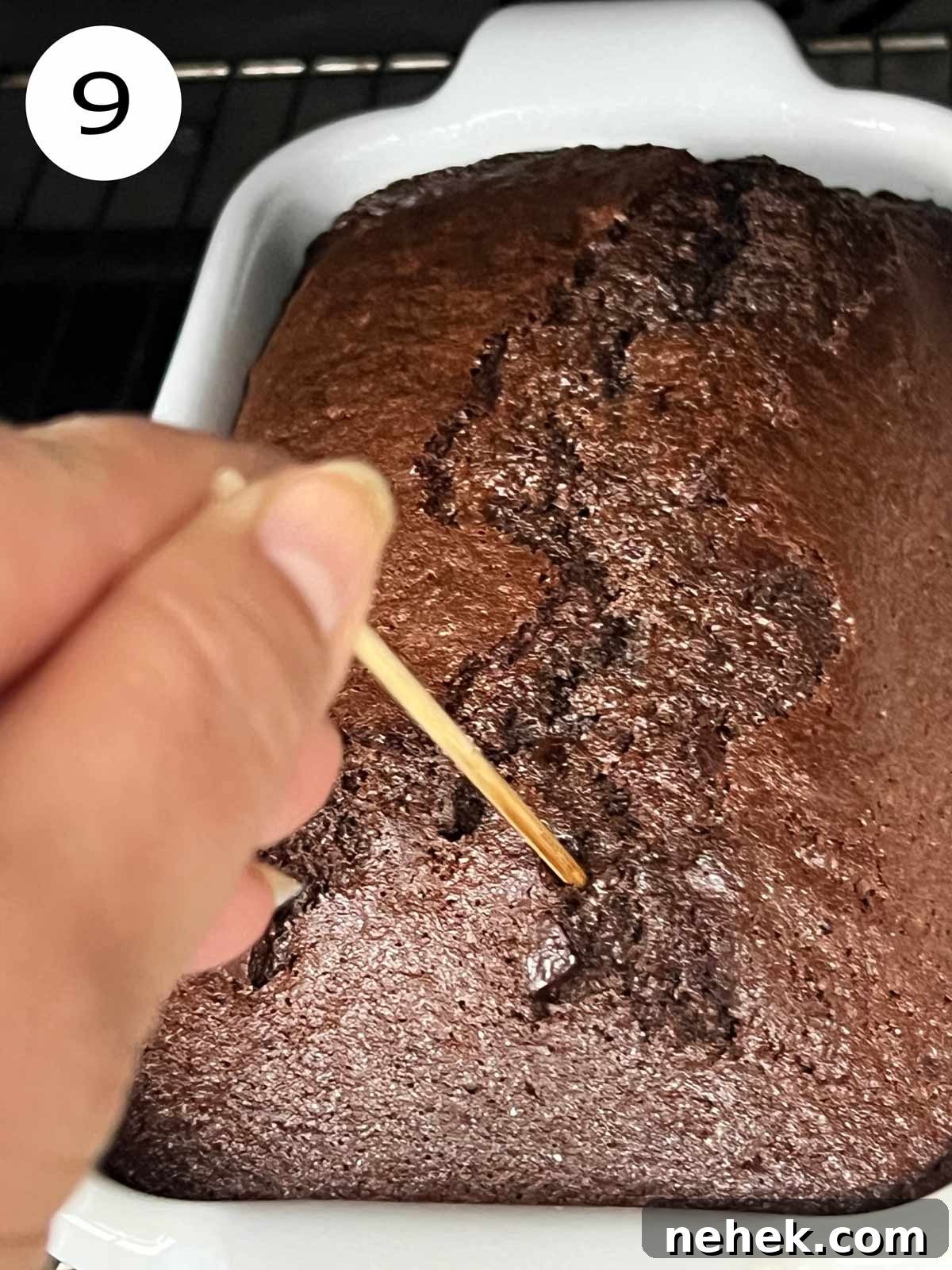 Ultimate Moist Chocolate Cake Recipe for Rich, Decadent Results 12 Moist chocolate cake with olive oil being poked with a wooden stick.