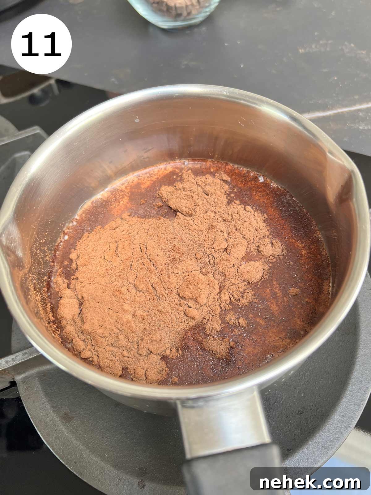 Ultimate Moist Chocolate Cake Recipe for Rich, Decadent Results 14 Cacao powder being added to the hot milk into a stainless steel pot that's placed on medium fire.