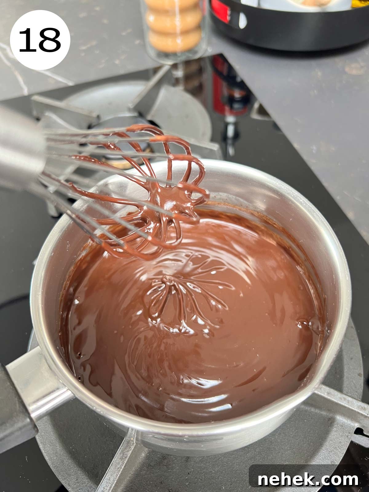 Ultimate Moist Chocolate Cake Recipe for Rich, Decadent Results 21 Ganache in a stainless steel pot being mixed.