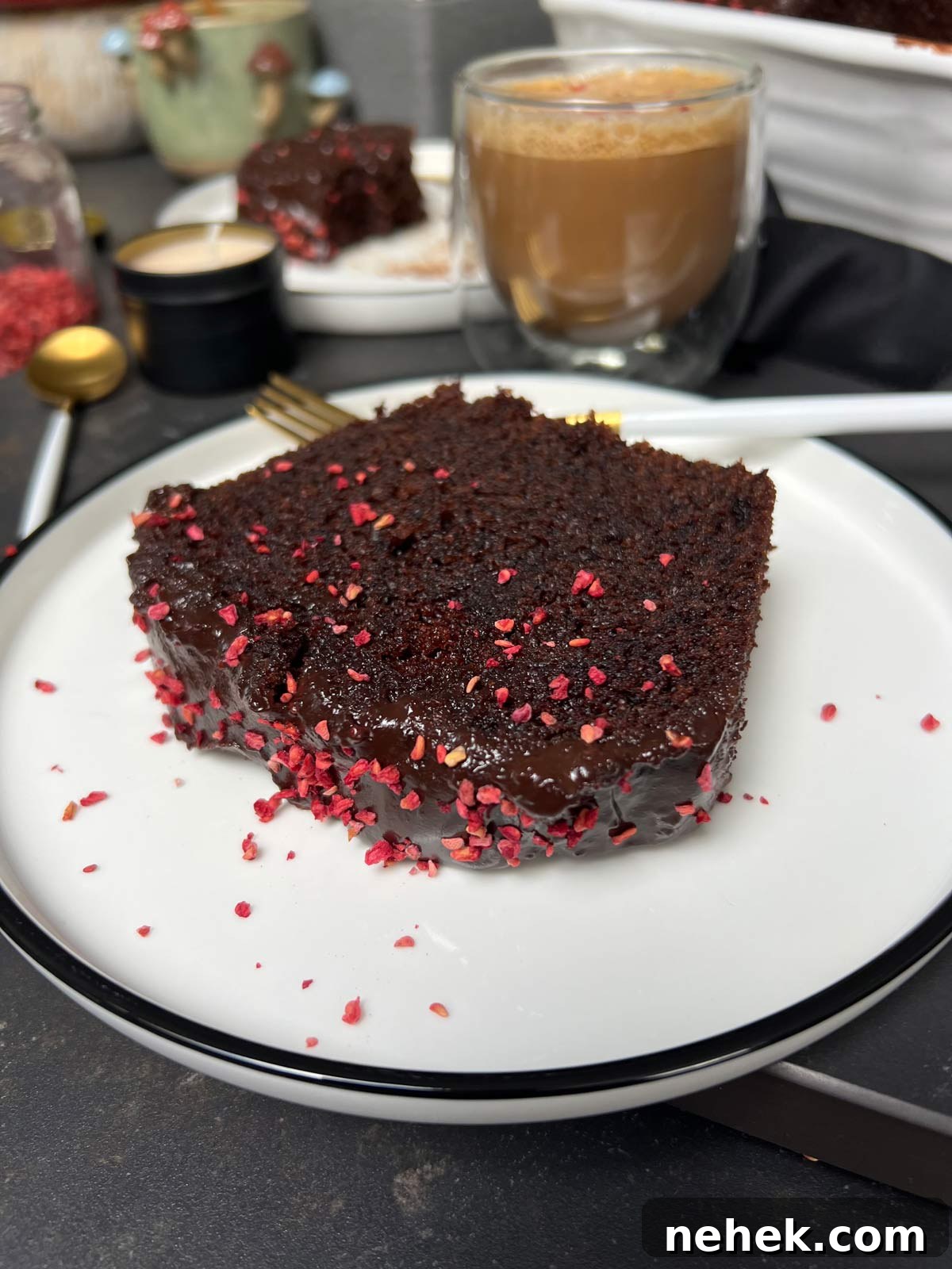 Ultimate Moist Chocolate Cake Recipe for Rich, Decadent Results 22 A slice of chocolate cake on a white plate and a fork.