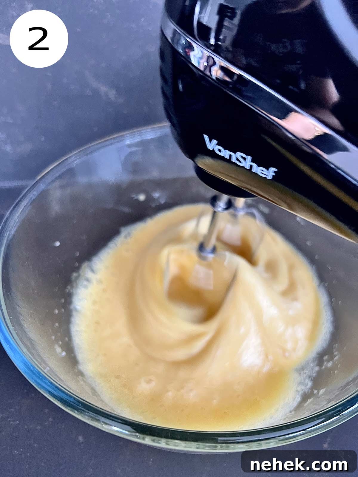 Ultimate Moist Chocolate Cake Recipe for Rich, Decadent Results 5 Eggs and sugar with salt being blended with a hand mixer.