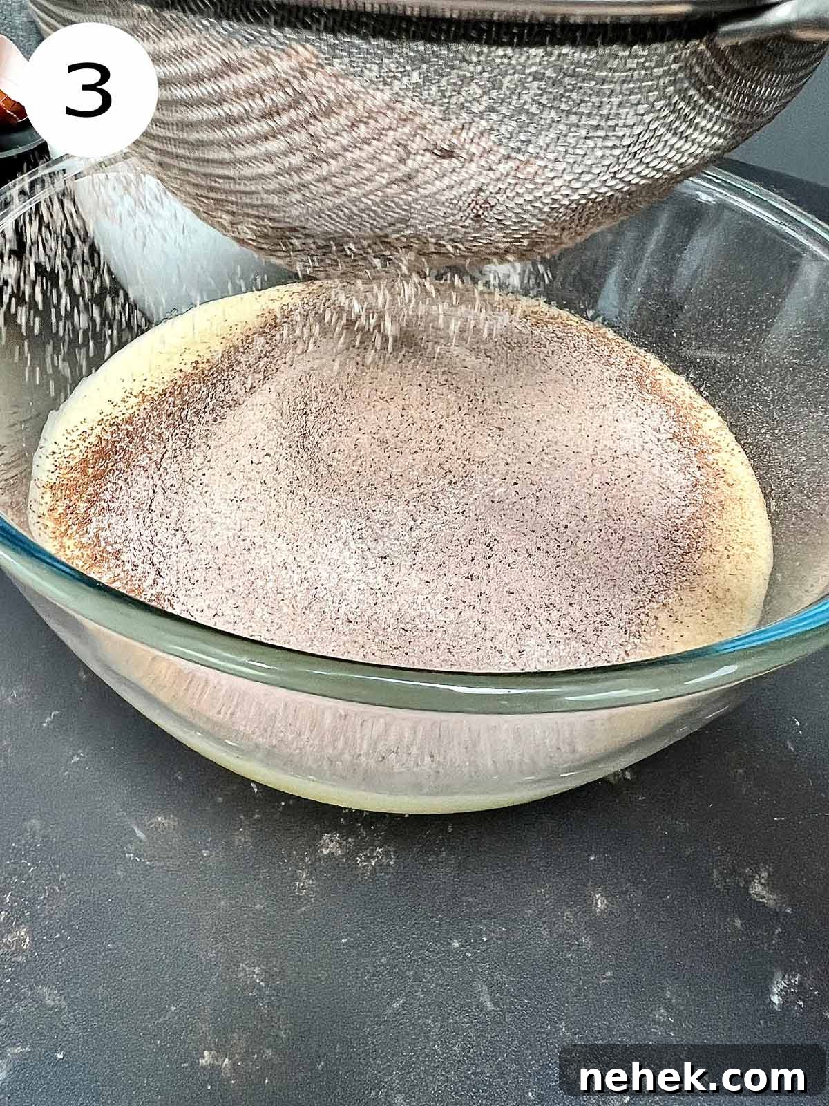 Ultimate Moist Chocolate Cake Recipe for Rich, Decadent Results 6 Flour and cocoa powder being sieved to the fluffy chocolate cake batter.