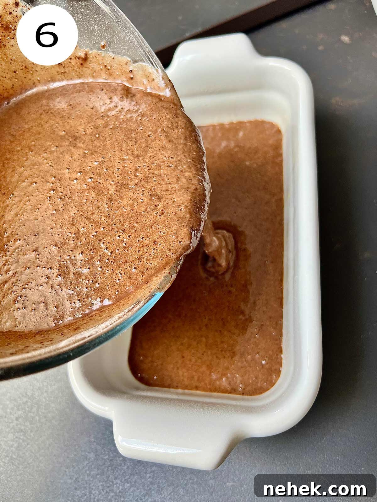 Ultimate Moist Chocolate Cake Recipe for Rich, Decadent Results 9 Chocolate cake mixture being poured into the oven dish.