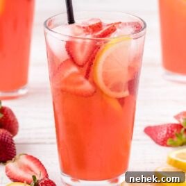 Refreshing Strawberry Lemonade Recipe for Summer Drinks 9 close up shot of a glass full of Strawberry Lemonade garnished with strawberries and lemon