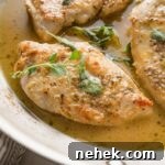 Savory Oregano-Roasted Chicken with Lemon and Garlic 7 Close up of a pan-fried chicken breast seasoned with white wine sauce and oregano.