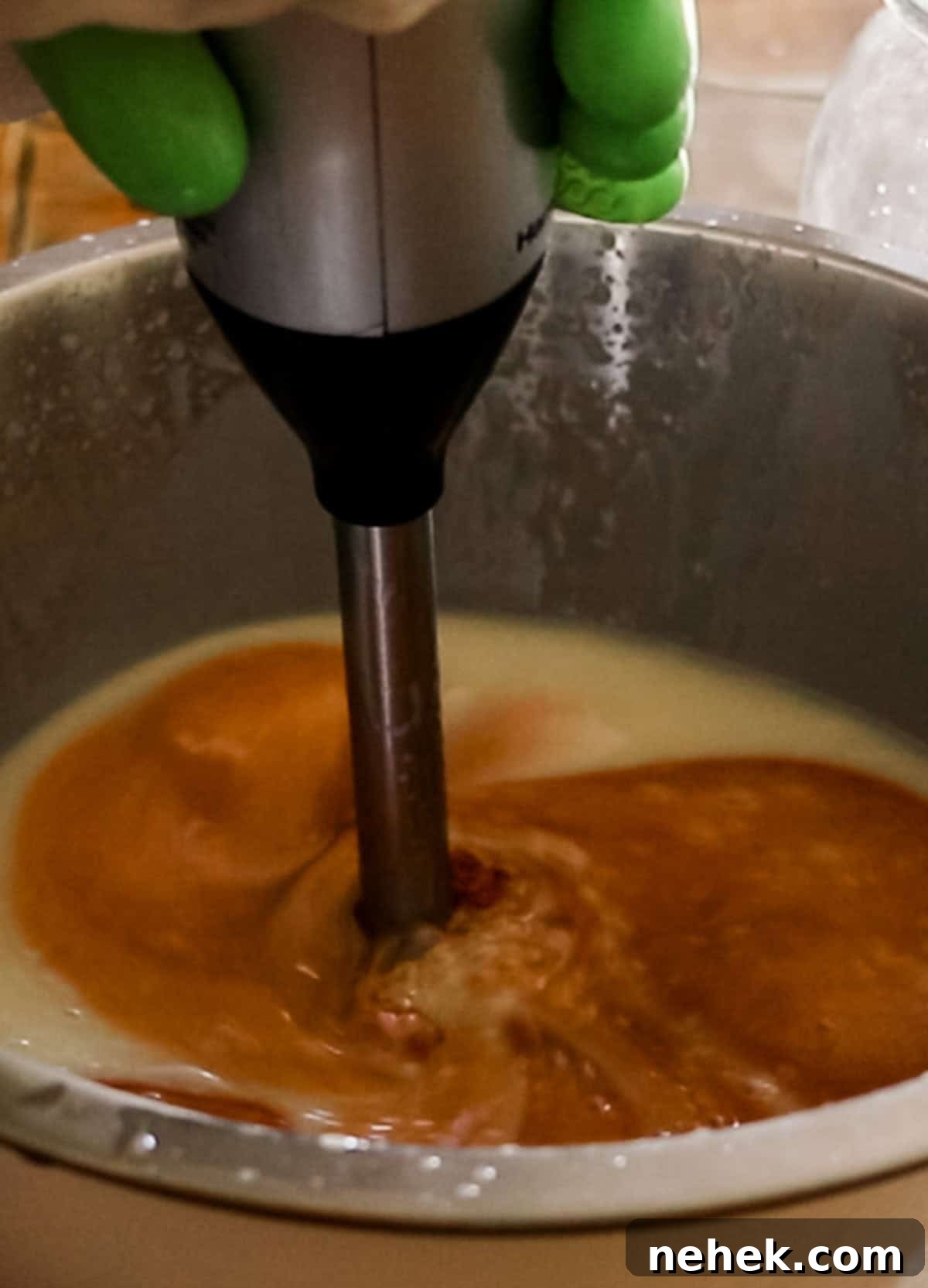 Homemade Turmeric Soap Recipe for Glowing Skin 11 Mixing turmeric into the soap ingredients with an immersion blender.
