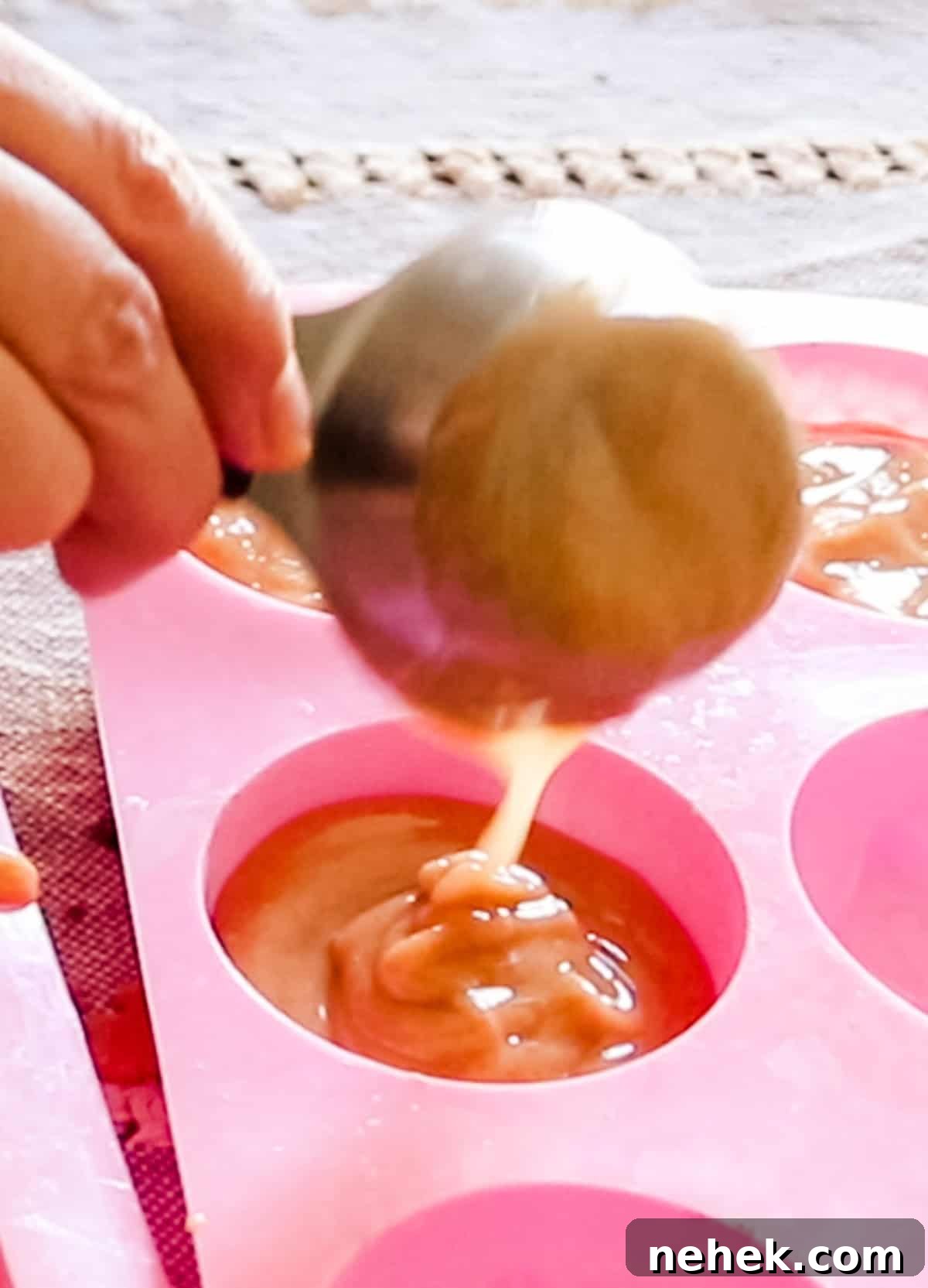 Homemade Turmeric Soap Recipe for Glowing Skin 12 Scooping soap mixture into a silicone soap mold.