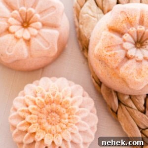 Homemade Turmeric Soap Recipe for Glowing Skin 15 Flower-shaped orange soap bars on a wicker placemat.