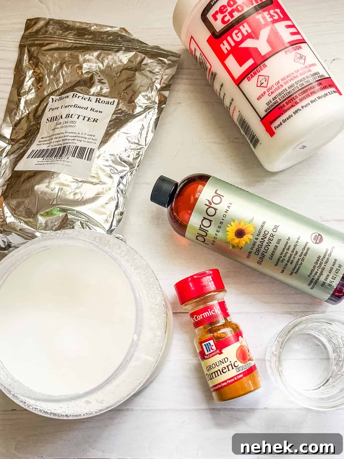 Homemade Turmeric Soap Recipe for Glowing Skin 4 Turmeric soap ingredients on a white countertop.