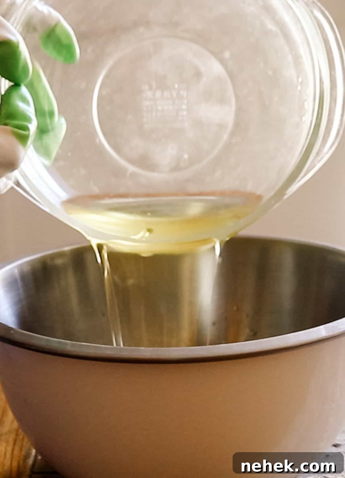 Homemade Turmeric Soap Recipe for Glowing Skin 9 Pouring melted fats into a metal bowl.