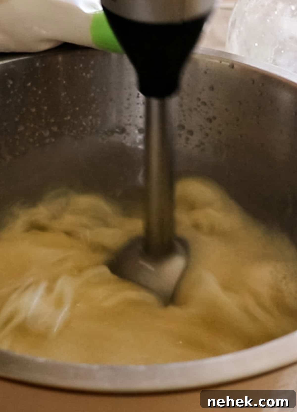 Homemade Turmeric Soap Recipe for Glowing Skin 10 Mixing soap mixture with an immersion blender.