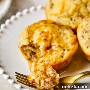 McGriddle Muffins on a plate with syrup and a fork taking a bite out