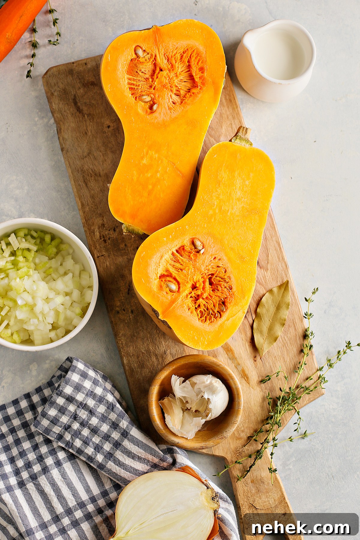 ingredients needed to make butternut apple soup on a cutting board
