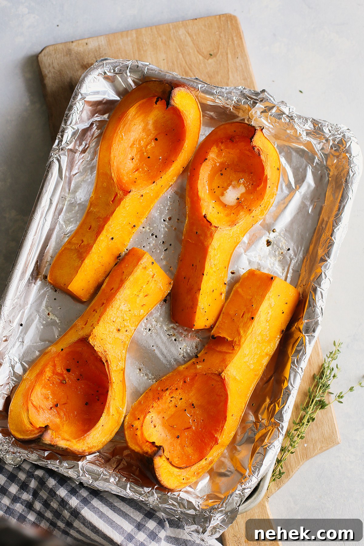 roasted butternut squash on a baking sheet to use to make a recipe for butternut and apple soup