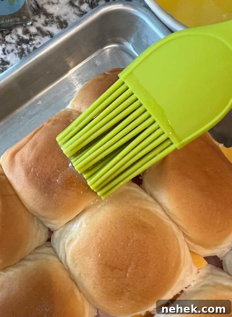 brush melted butter over ham and cheese sandwiches