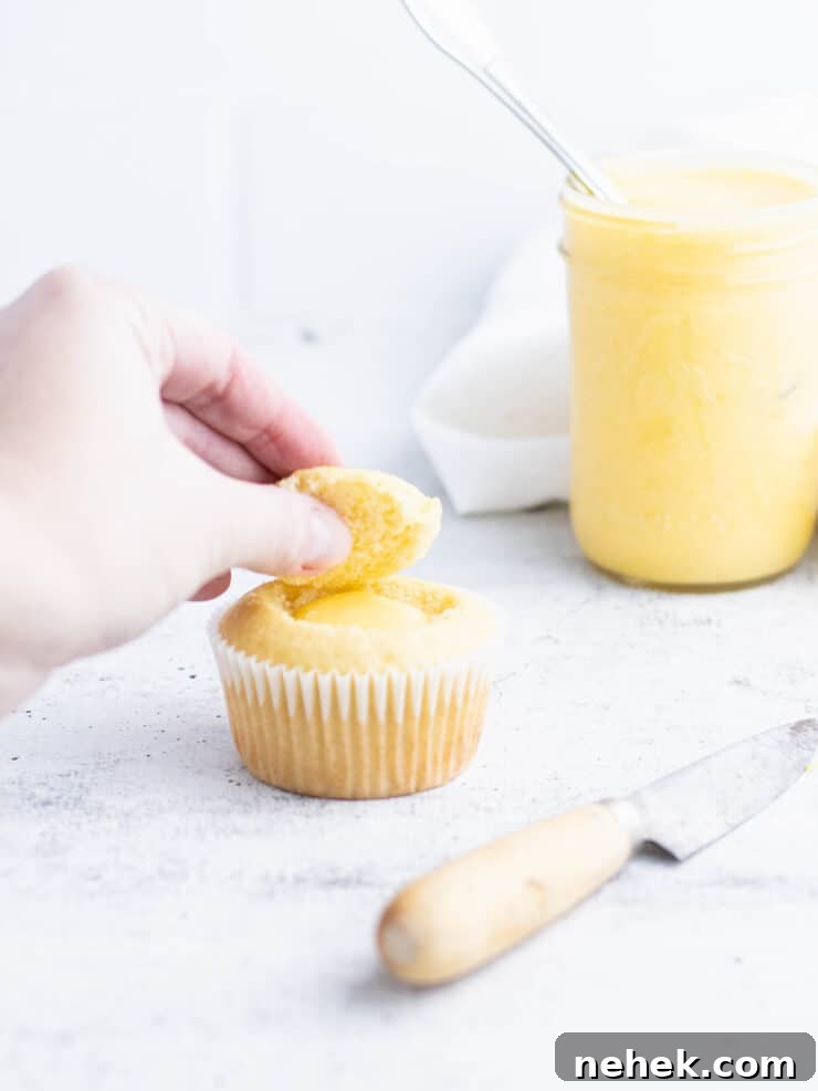 How to Fill Cupcakes Perfectly: 6 Methods for Delicious Centers 8 Top of a cupcake being replaced over filling.