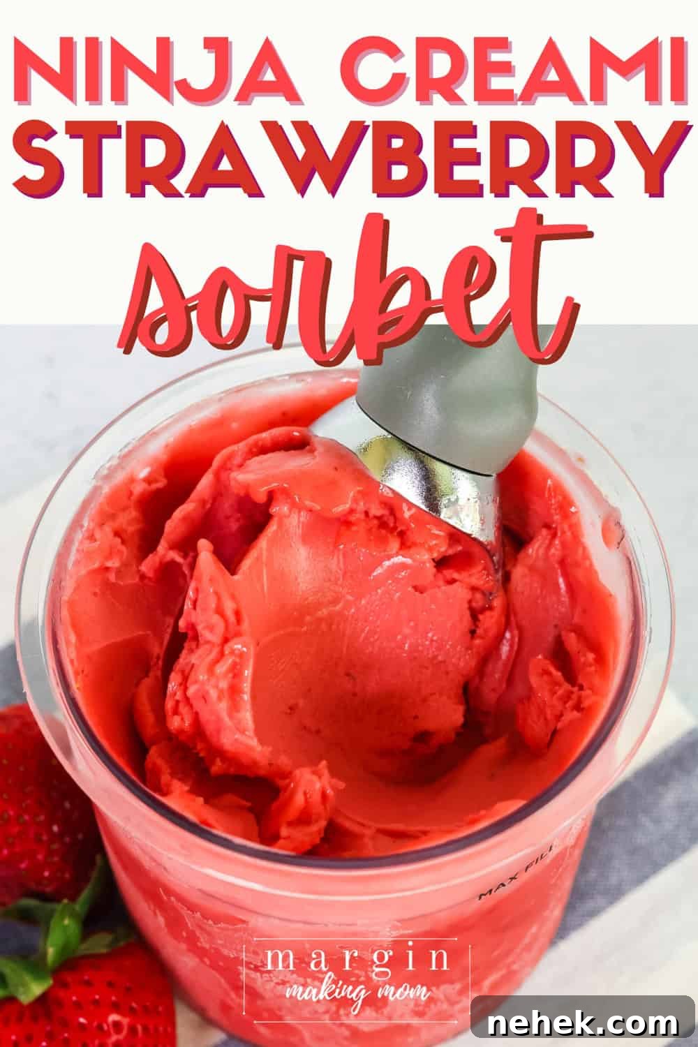 Ninja Creami strawberry sorbet in a pint container, with an ice cream scoop in it.