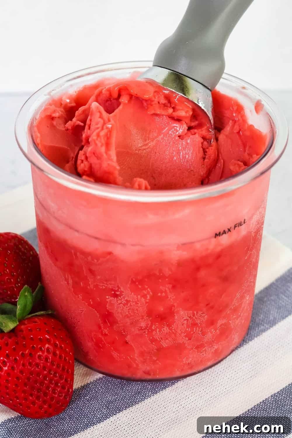 pint of healthy Ninja Creami strawberry sorbet made with fresh strawberries.