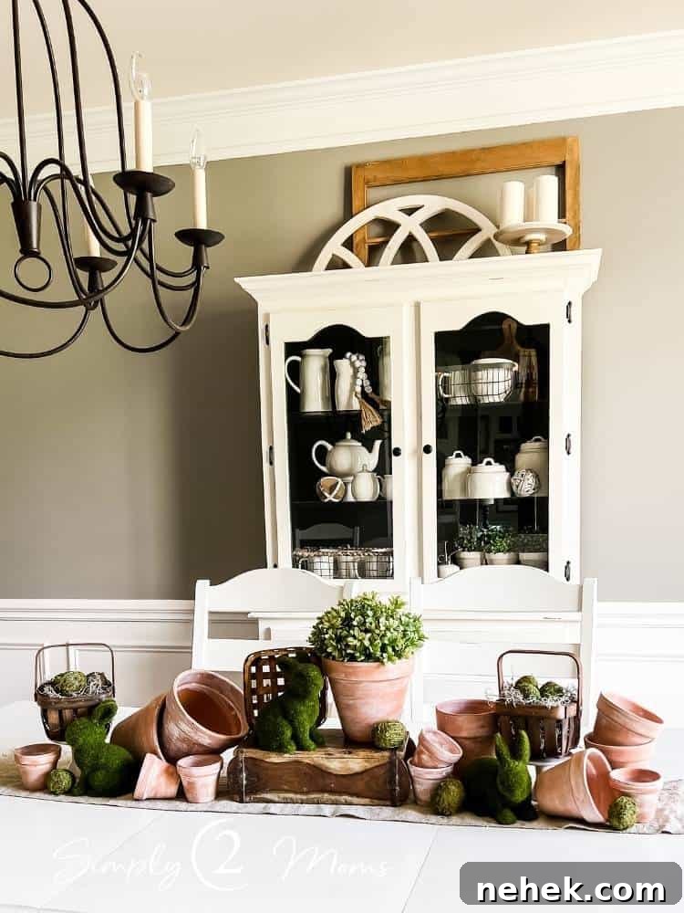 spring Easter centerpiece in middle of dining table with china hutch against wall