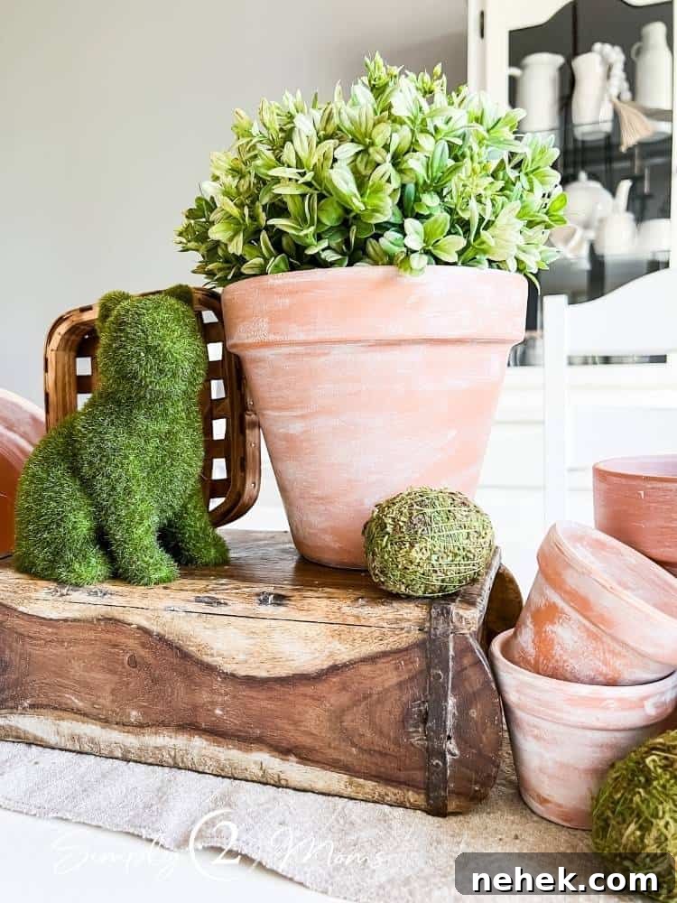 faux aged terra cotta pots used as basis of spring tablescape