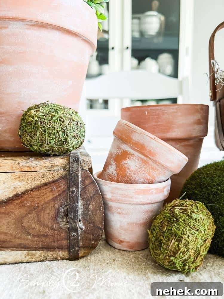 moss covered faux eggs with diy distressed terracotta flower pots
