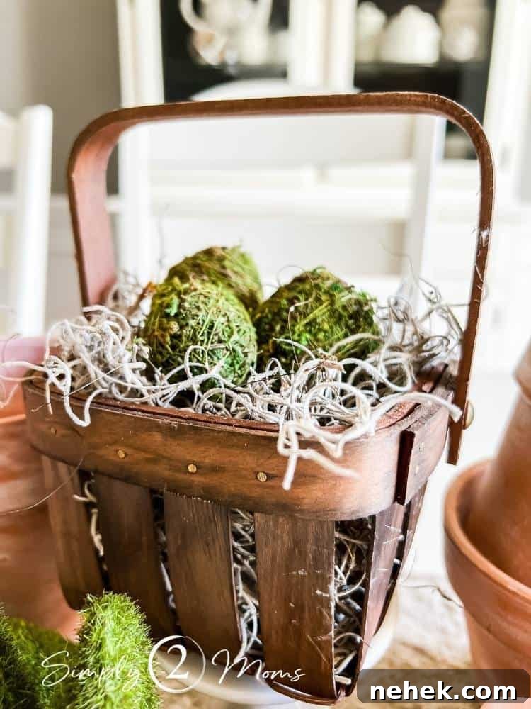 mini wood basket filled with Spanish moss grass and moss covered eggs