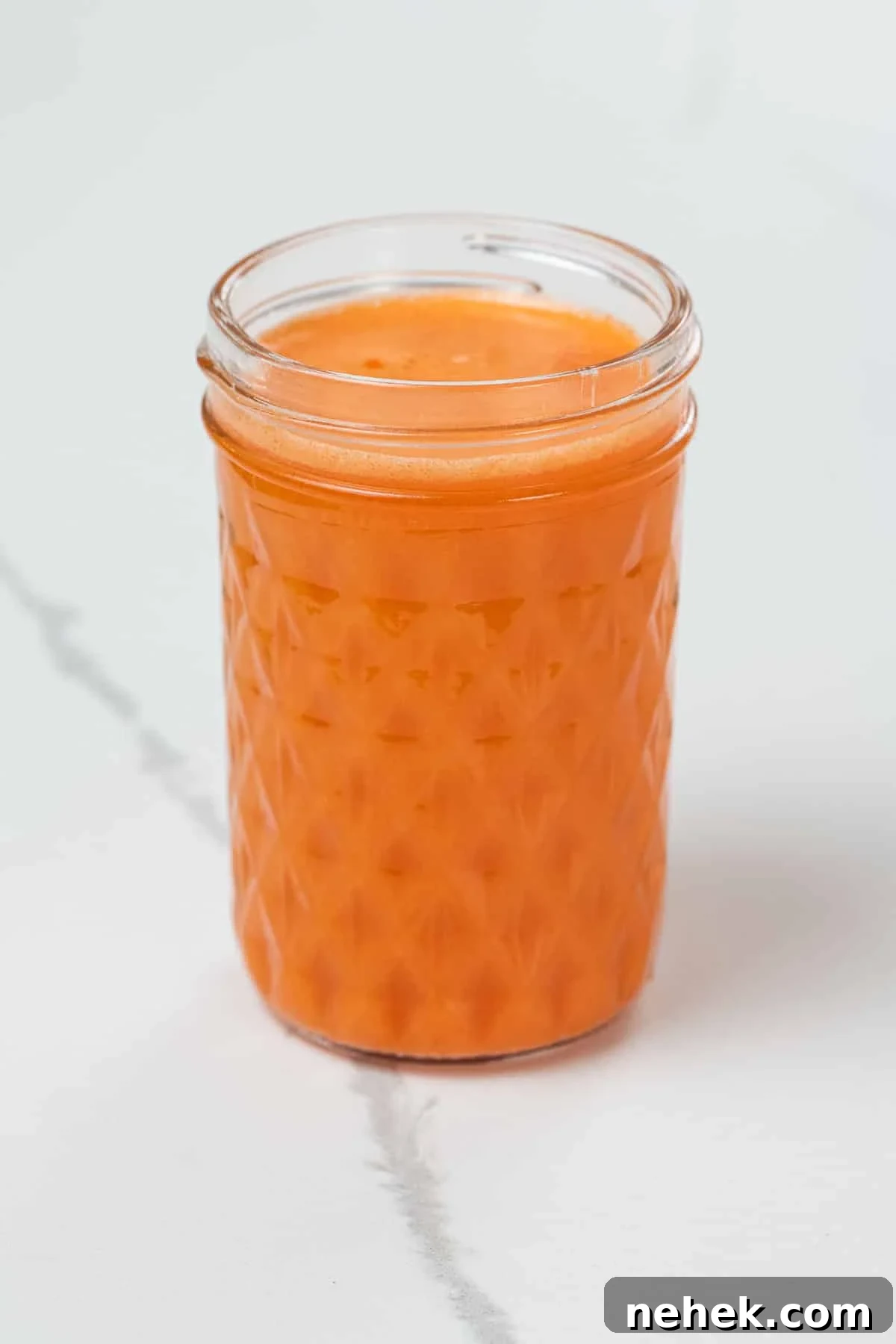 sweet potato, carrot, and orange juice in a small glass